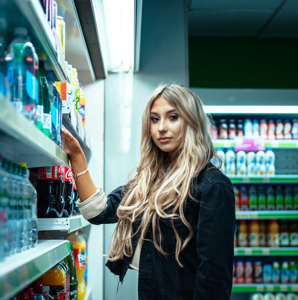 woman standing beside store shelf