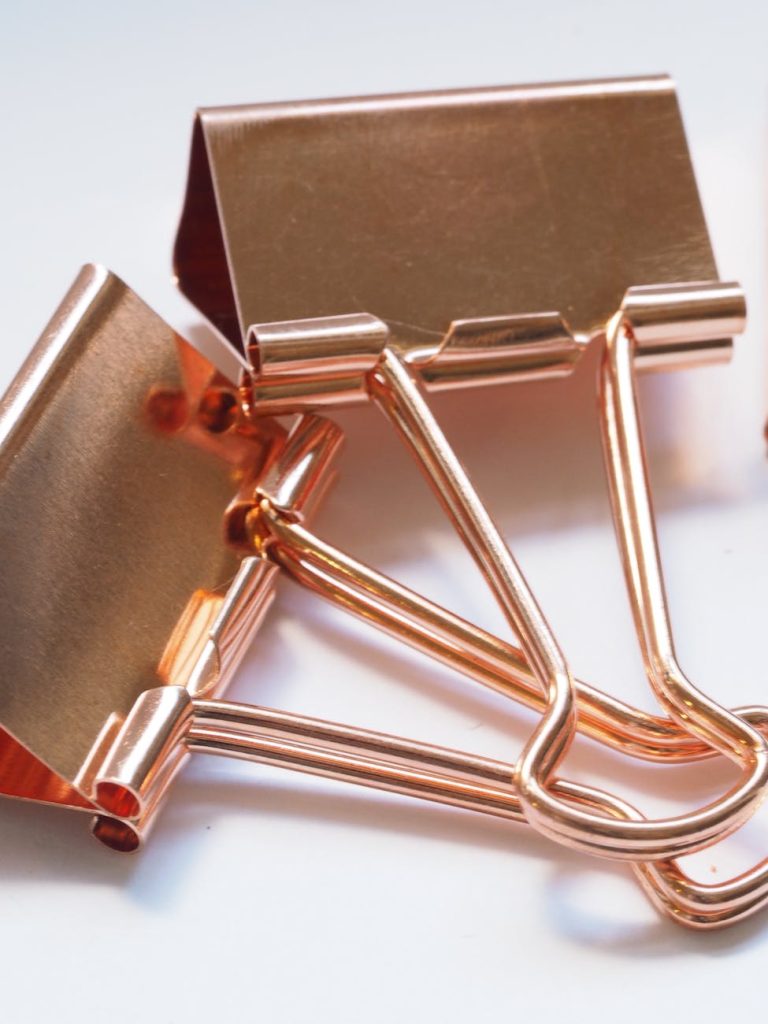 two gold binder clips