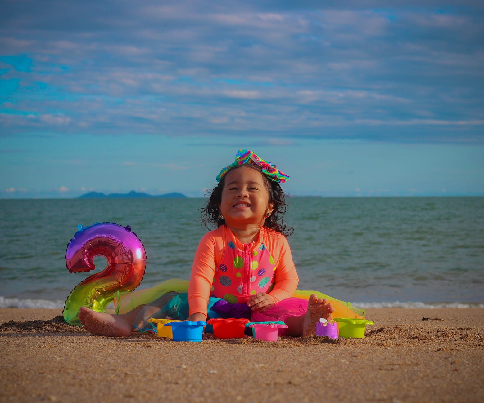 little girl with balloon on a beach