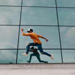 man running beside mirror wall