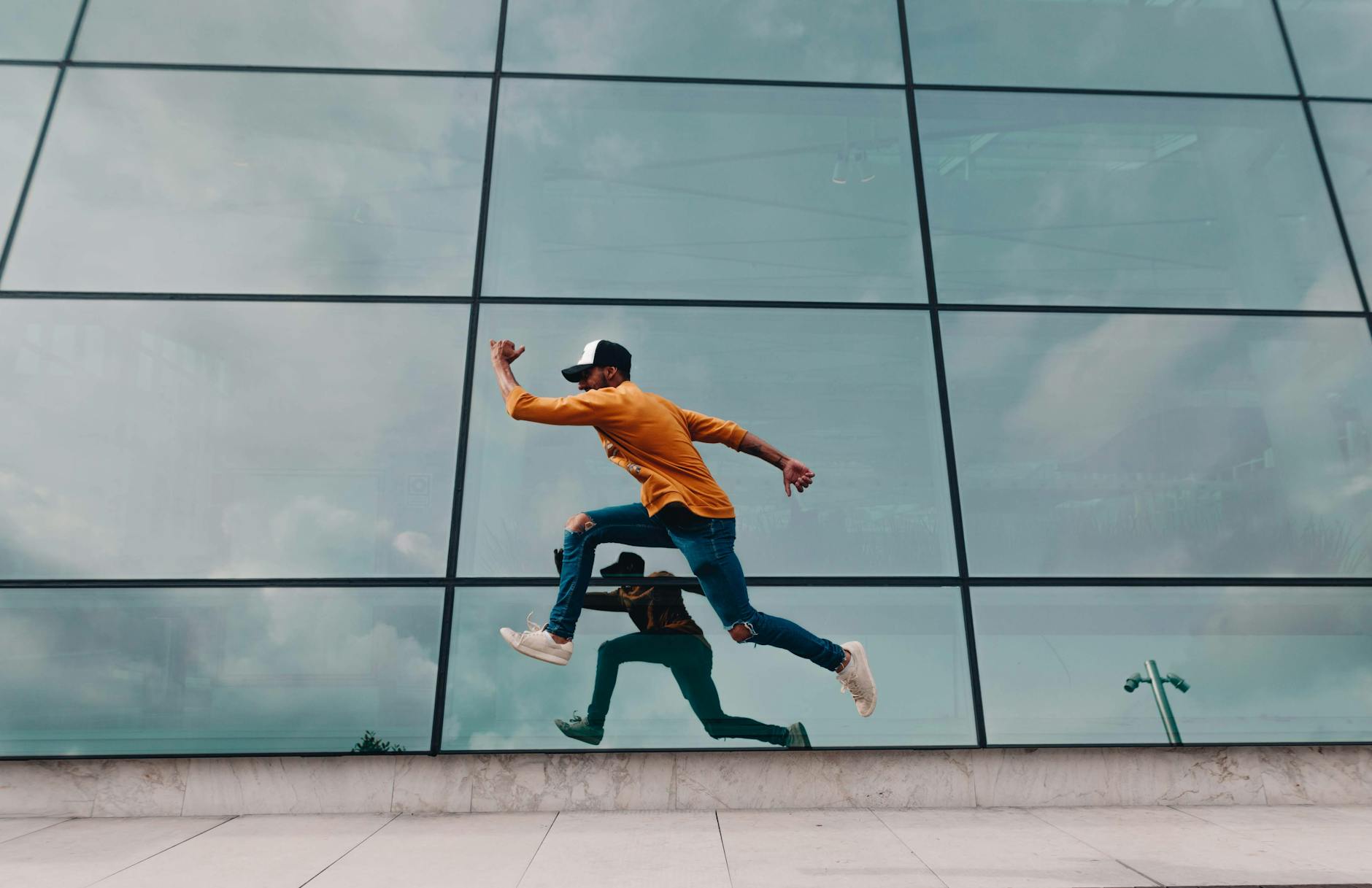 man running beside mirror wall