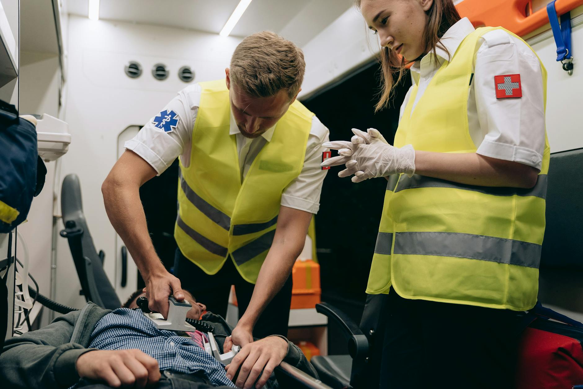 paramedics using a defibrillator on a patient